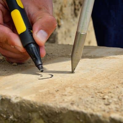 Marking layout points during a construction survey to ensure accurate placement on a job site