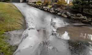Water pooling on a sloped driveway showing how a topographic survey can help identify drainage and grading issues