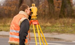 Surveyor using total station during an ALTA survey in West Virginia