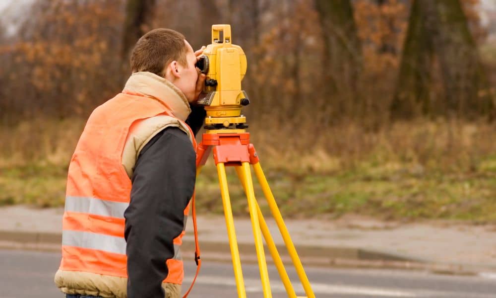 Surveyor using total station during an ALTA survey in West Virginia