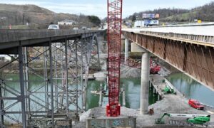Aerial survey view of I-79 bridge construction in Bridgeport, highlighting cranes, concrete pillars, and ongoing highway work