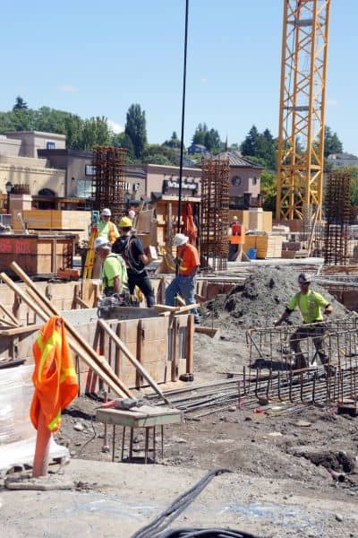 Construction site with crane and workers where survey data ensures FAA compliance

