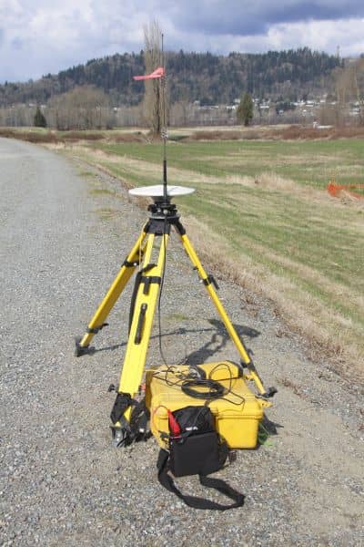 Surveying equipment set up in the field to collect elevation data for a topo survey