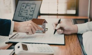 Real estate professionals reviewing documents for an ALTA Land Title Survey before a property closing