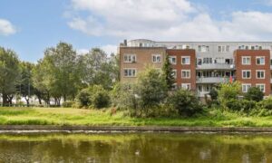 Residential building near water showing how a FEMA elevation certificate can help determine flood risk and insurance costs