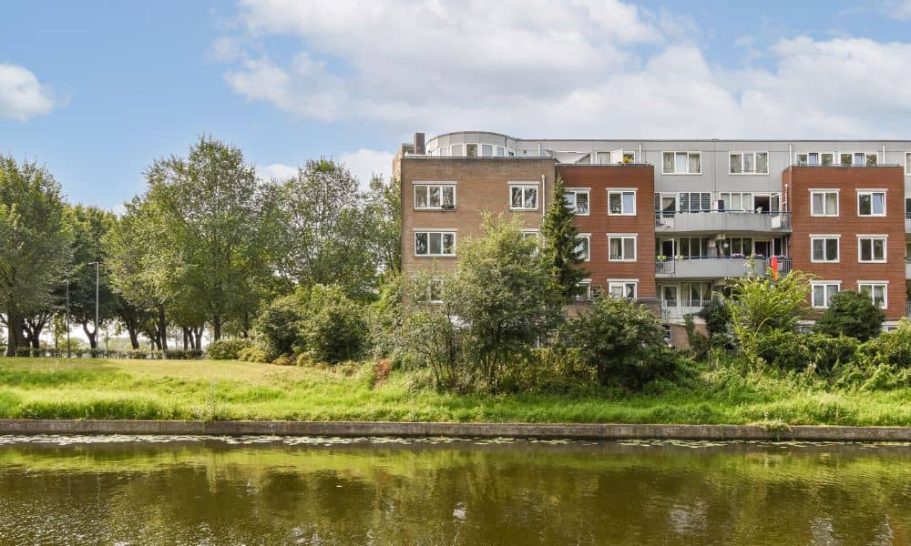 Residential building near water showing how a FEMA elevation certificate can help determine flood risk and insurance costs