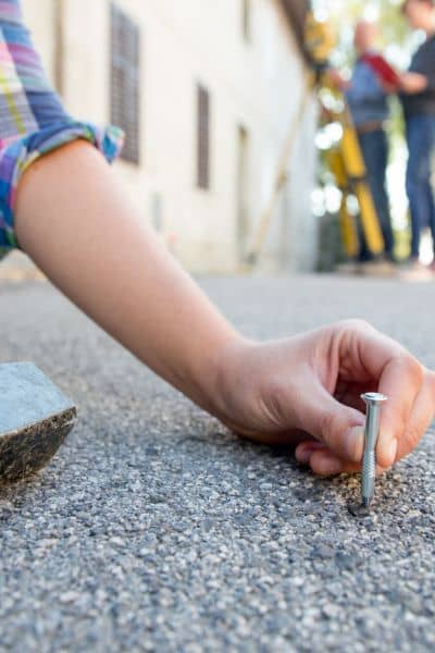 Surveyor installing a boundary marker during a boundary survey to establish the exact property line